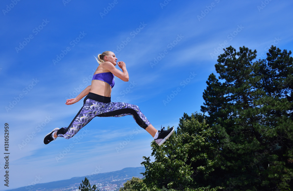 Young woman joyfully jumping in Park Young woman joyfully jumping in Park