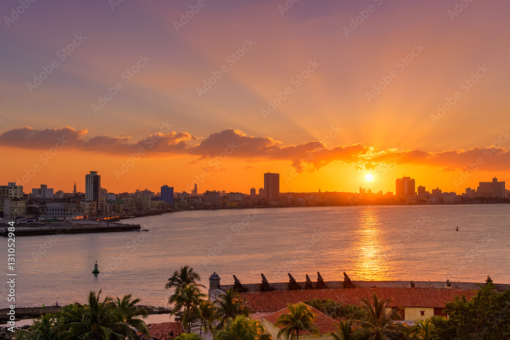 Beautiful sunset in Havana with the sun setting over the seaside buildings