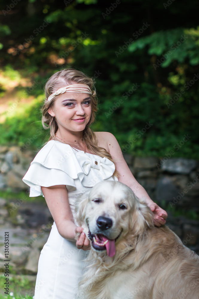 beautiful girl in white dress with a white dog in the garden beautiful girl in white dress with a white dog in the garden