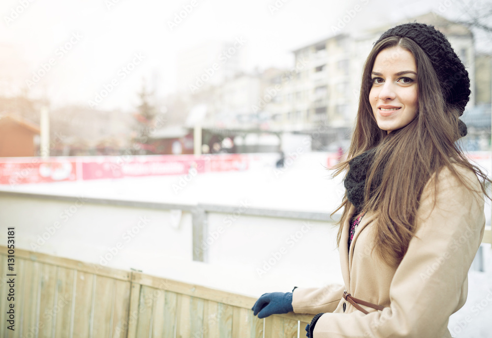 Fototapeta premium Woman posing at outdoor ice-skating park