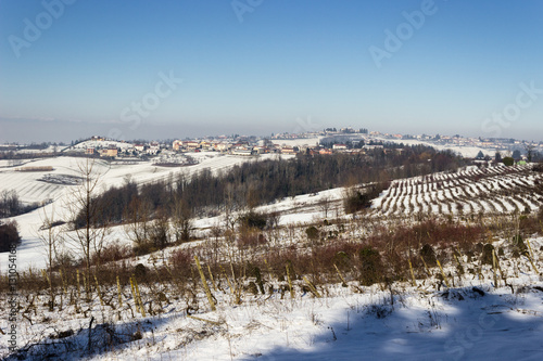 Winter colors in the Monferrato hills (Piedmont, Italy). Vineyards and fields are covered by snow.