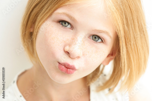 Closeup portrait of attractive teenager girl with freckles