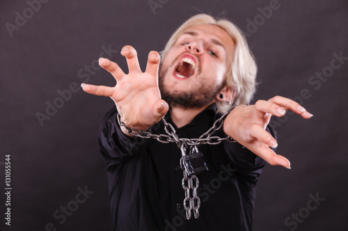 Screaming man with chained hands, no freedom