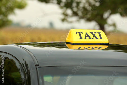 Taxi car on blurred background, close up view