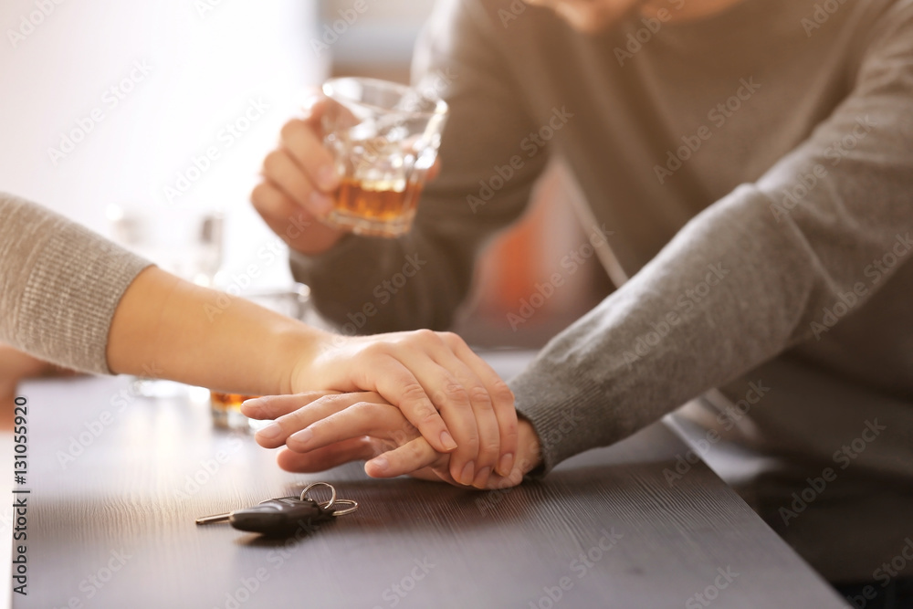 Woman preventing drunk man from taking car keys, closeup. Don't drink and drive concept