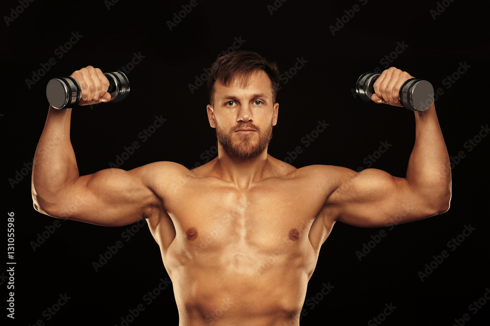 Sporty young man with dumbbells on black background Sporty young man with dumbbells on black background