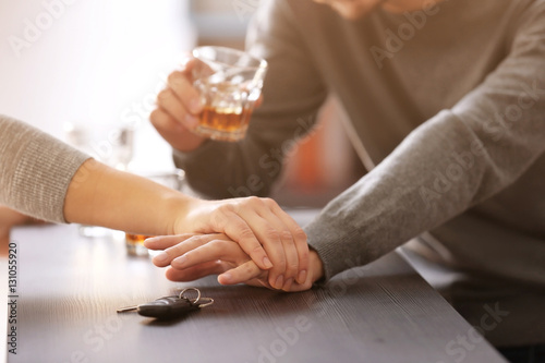 Woman preventing drunk man from taking car keys, closeup. Don't drink and drive concept
