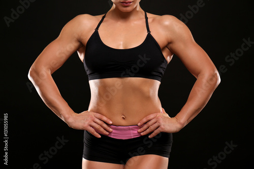 Sporty young woman on black background, closeup