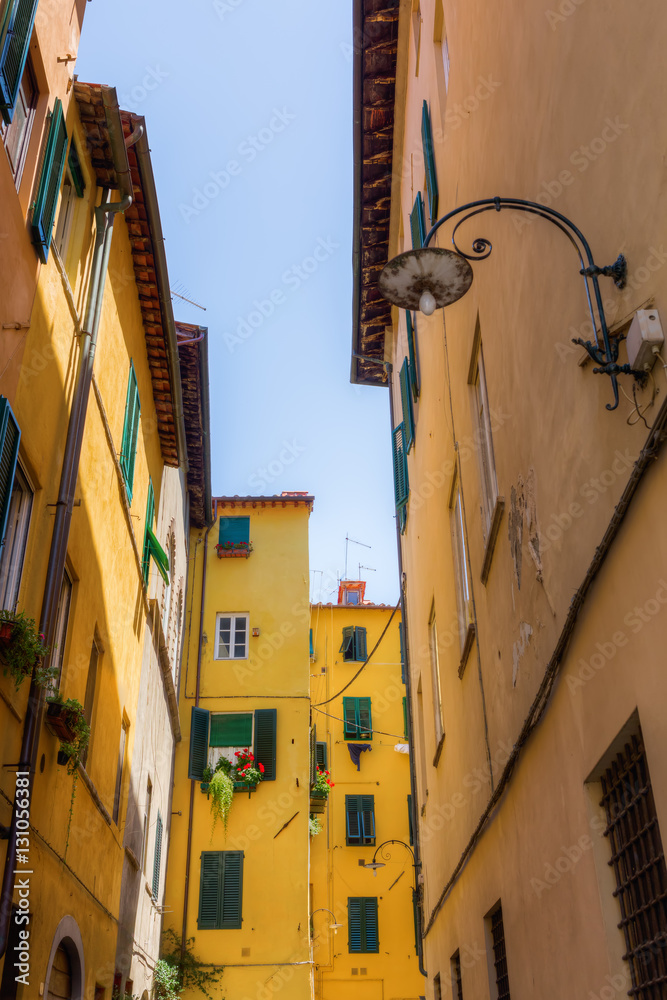 alley with old buildings in Lucca, Italy