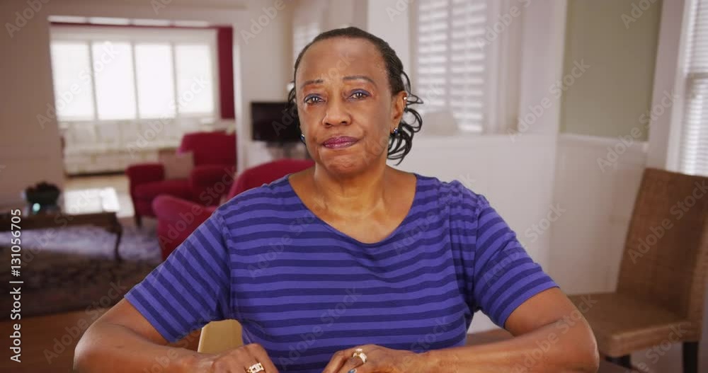 An older black woman acting concerned in a portrait. An elderly African American woman posing for a portrait while sad An older black woman acting concerned in a portrait. An elderly African American woman posing for a portrait while sad