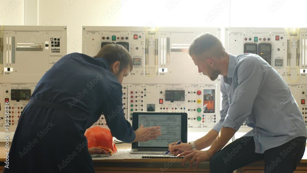 Engineer and foreman working at control room of a modern thermal power plant