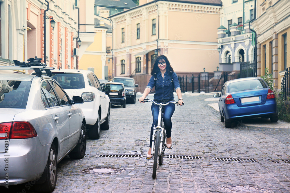 Pretty young woman riding bike outdoors Pretty young woman riding bike outdoors