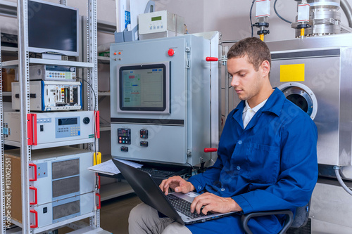 Young engineer working with a laptop working in a scientific laboratory