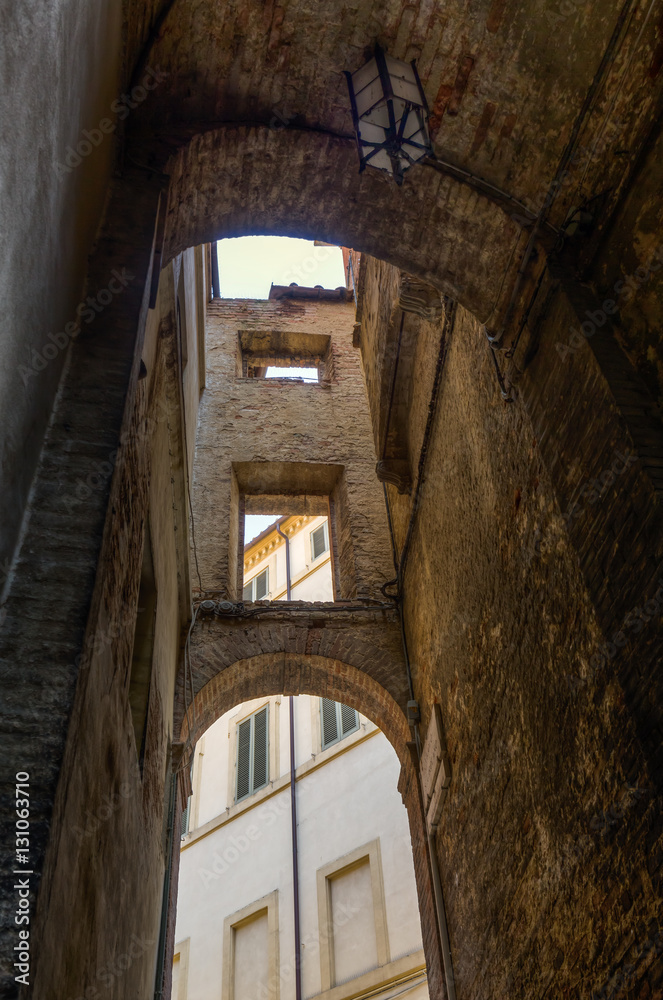 arches between historical buildings in Siena