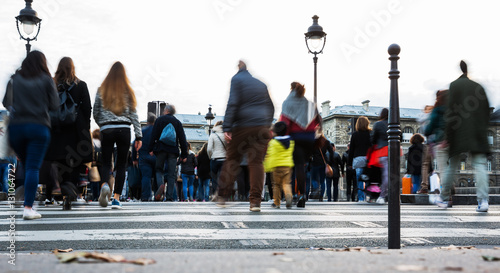 crowds of people crossing a city street