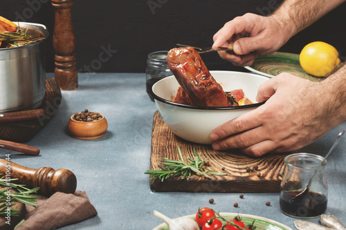 Quadro su tela Photo of a meat cooking process with ingredients