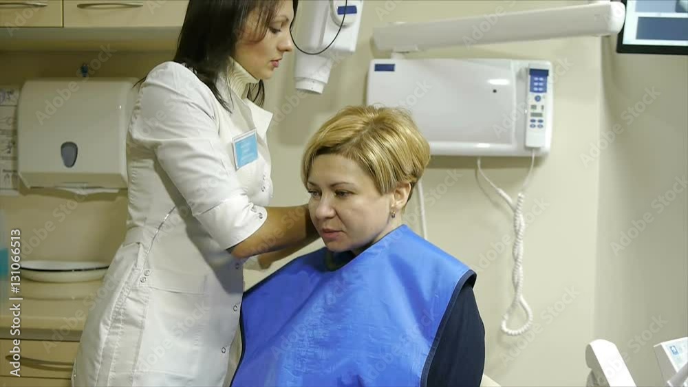 Dentist take jaw x-ray of female patient Dentist take jaw x-ray of female patient