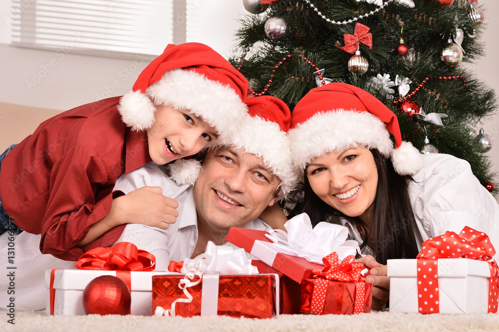 mother father and son near christmas tree mother father and son near christmas tree