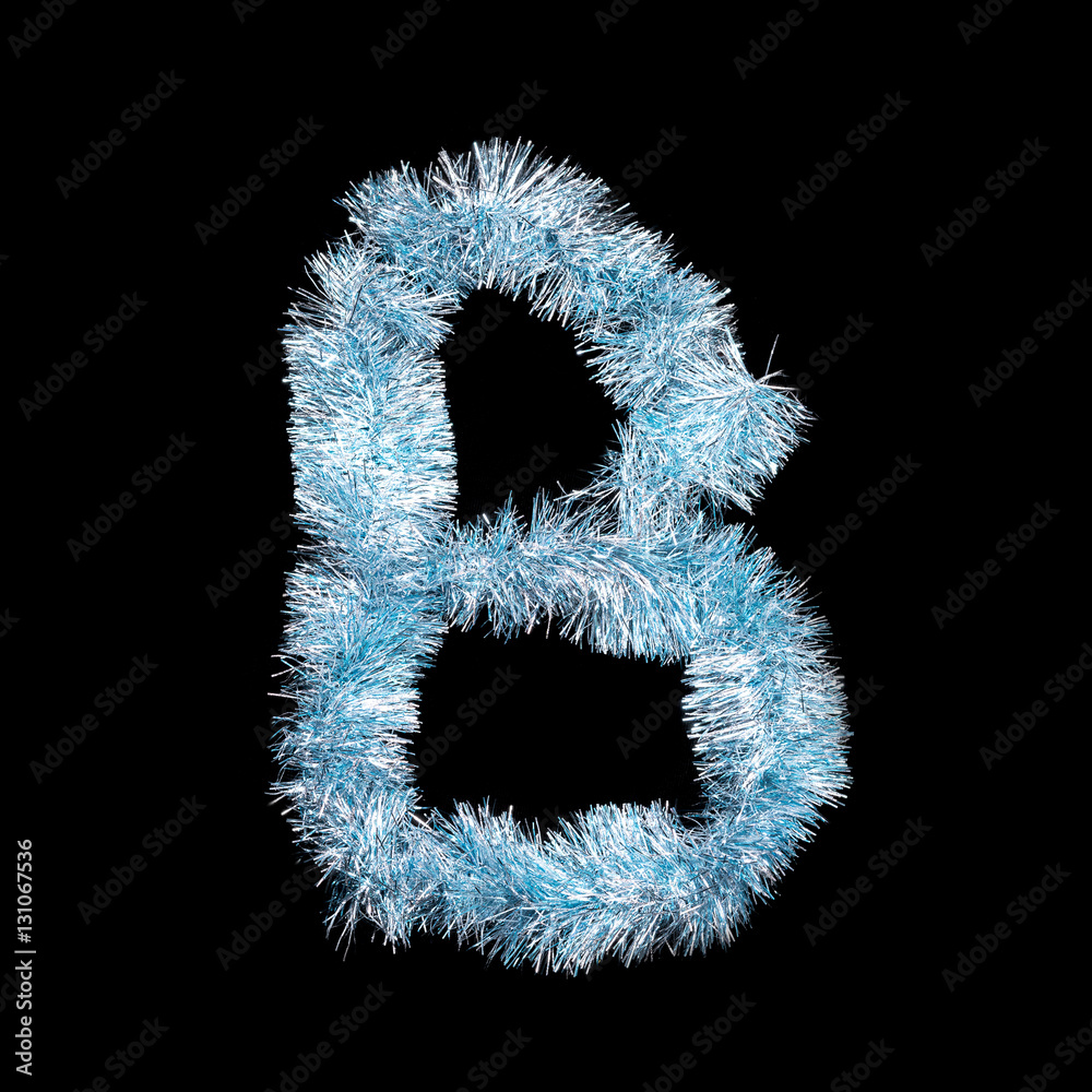 Festive alphabet made of blue tinsel. Letter B on black background. Isolated