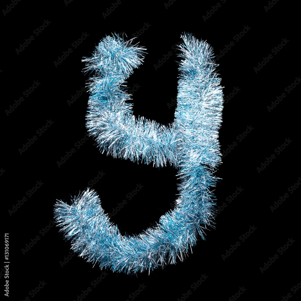 Festive alphabet made of blue tinsel. Letter Y on black background. Isolated Festive alphabet made of blue tinsel. Letter Y on black background. Isolated