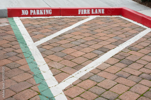 Painted red curb with no parking and fire lane