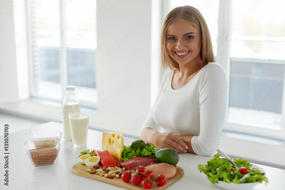 Healthy Nutrition. Beautiful Woman With Salad, Foods On Table