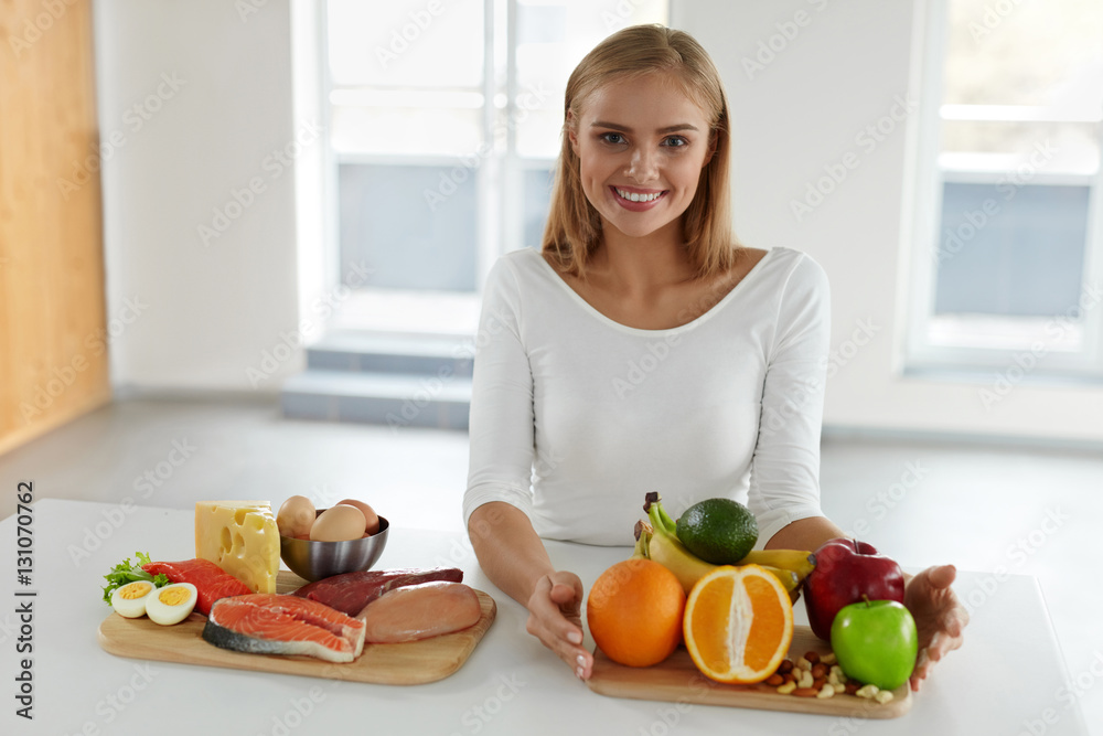 Diet Nutrition. Beautiful Woman With Foods, Products In Kitchen Diet Nutrition. Beautiful Woman With Foods, Products In Kitchen