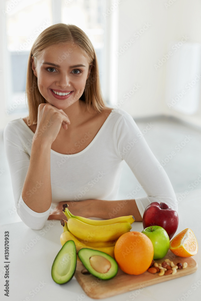 Beautiful Woman With Fruits In Kitchen. Nutrition And Vitamins Beautiful Woman With Fruits In Kitchen. Nutrition And Vitamins