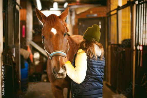 Fotografie Female rider trains the horse out of the stables