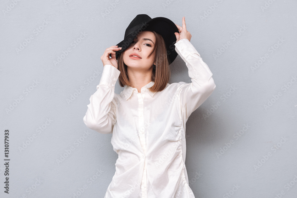 Pretty young woman posing in hat and looking at camera Pretty young woman posing in hat and looking at camera