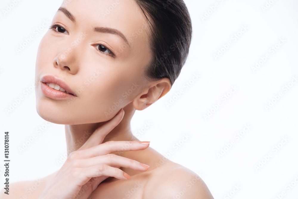 Involved young Korean woman expressing grace in the studio