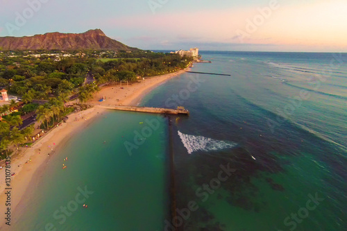 Aerial view of Honolulu, Hawaii's Waikiki Beach and Diamond Head at sunset photo