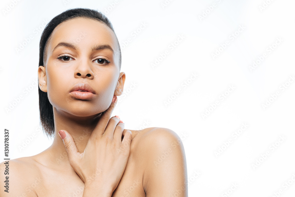 Graceful young Negroid woman expressing charm in the studio Graceful young Negroid woman expressing charm in the studio