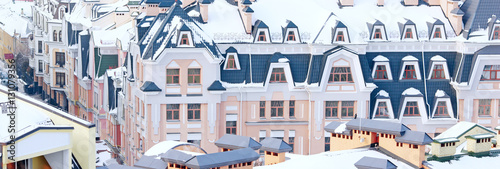 painted houses and colored roof covered with snow in winter