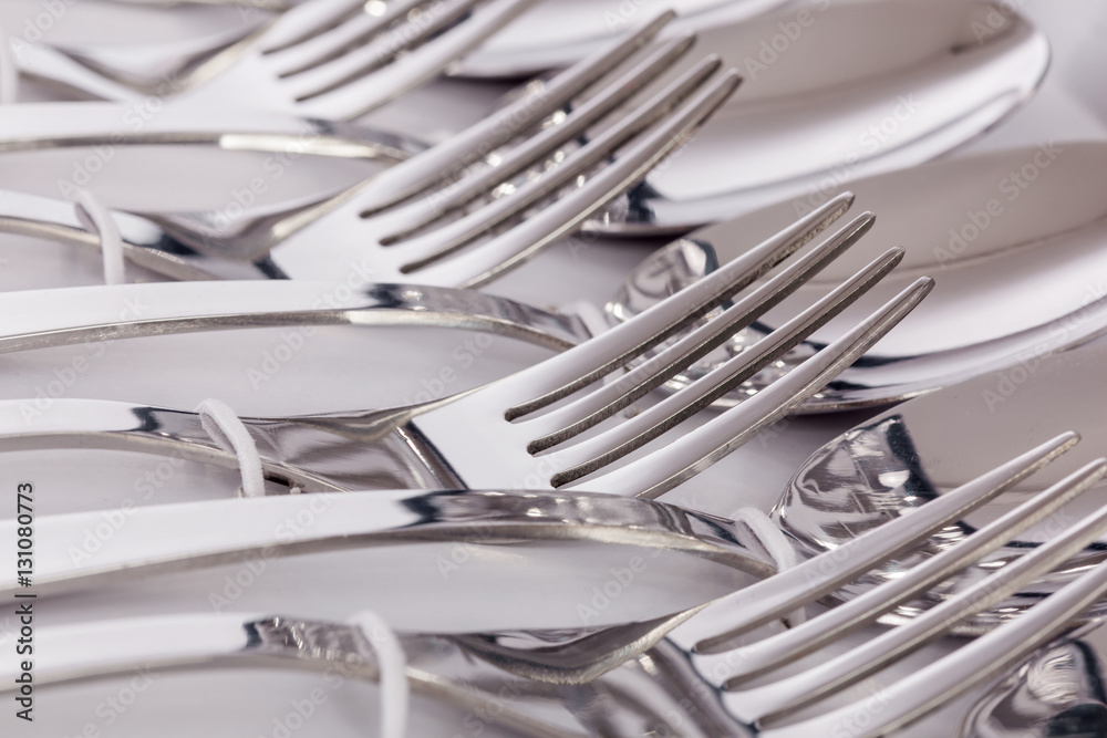 Close up macro detail of a flatware box set with forks and spoons. Close up macro detail of a flatware box set with forks and spoons.