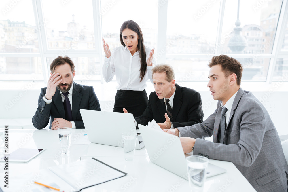 Shocked Business team by the table Shocked Business team by the table