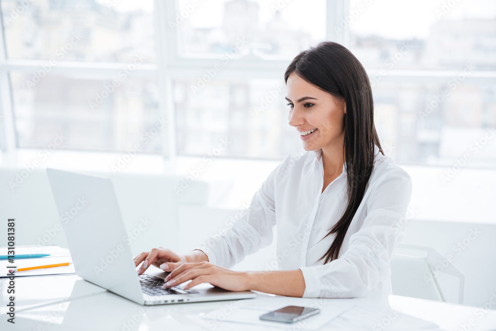 Side view of business woman using laptop Side view of business woman using laptop