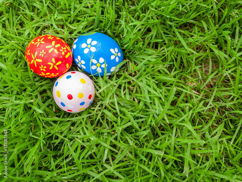 Hand painted Easter eggs hidden on the grass ready for the easter egg hunt traditional play game. Top view.
