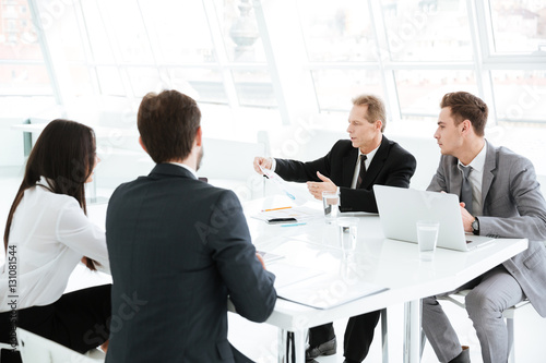 Business group sitting by the table