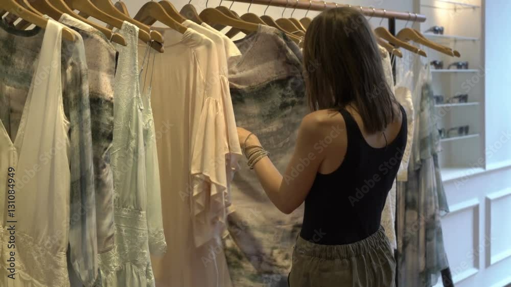 Young, attractive woman checking clothes at shop
Young, attractive woman checking clothes at shop
