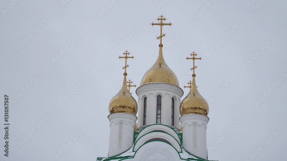 church with crosses and domes of Russia Russian church a gray background
