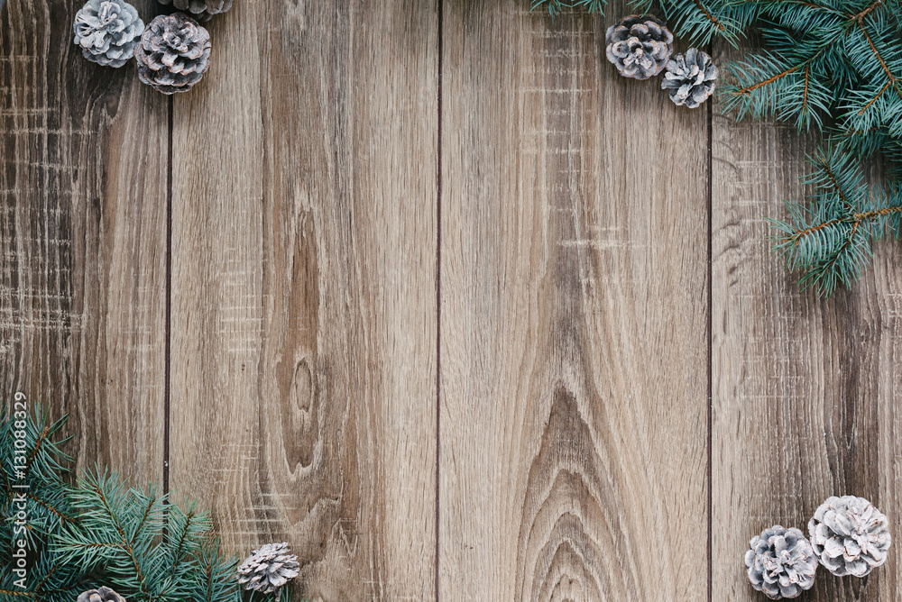 Christmas decorations, pine needles and cones on white wooden background Christmas decorations, pine needles and cones on white wooden background