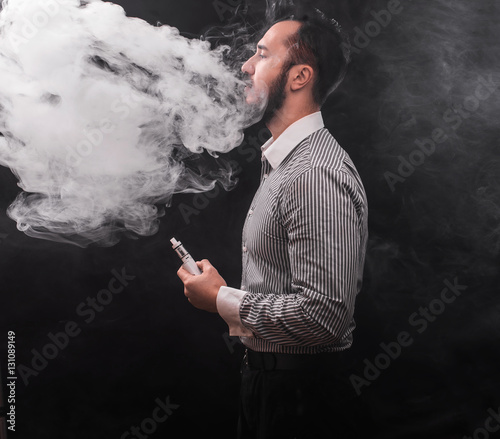 man smoking electronic cigarette vaponizer