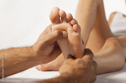 reflexology and acupressure on women's feet photo
