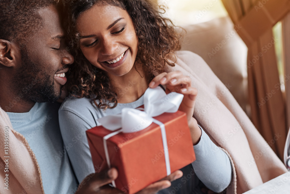 Smiling African American woman receiving congratulations from her boyfriend Smiling African American woman receiving congratulations from her boyfriend