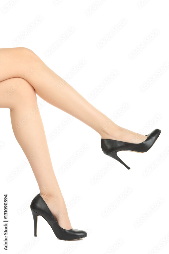 Beautiful female legs in black shoes with high heels. Isolate.