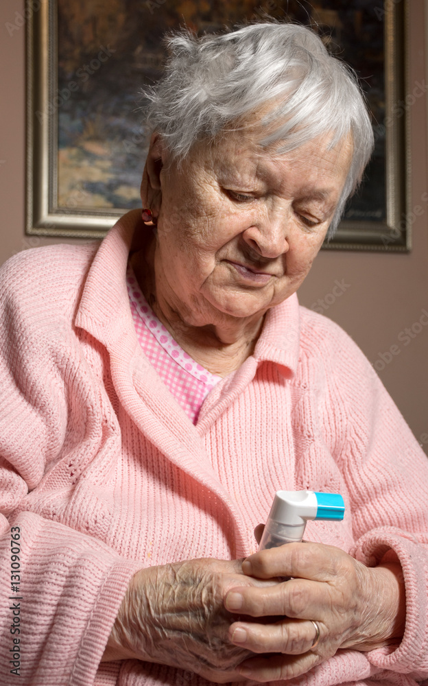 Old sick woman with asthma inhaler Stock-Foto | Adobe Stock