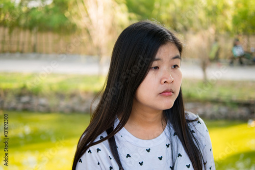 Bored asian woman in a park