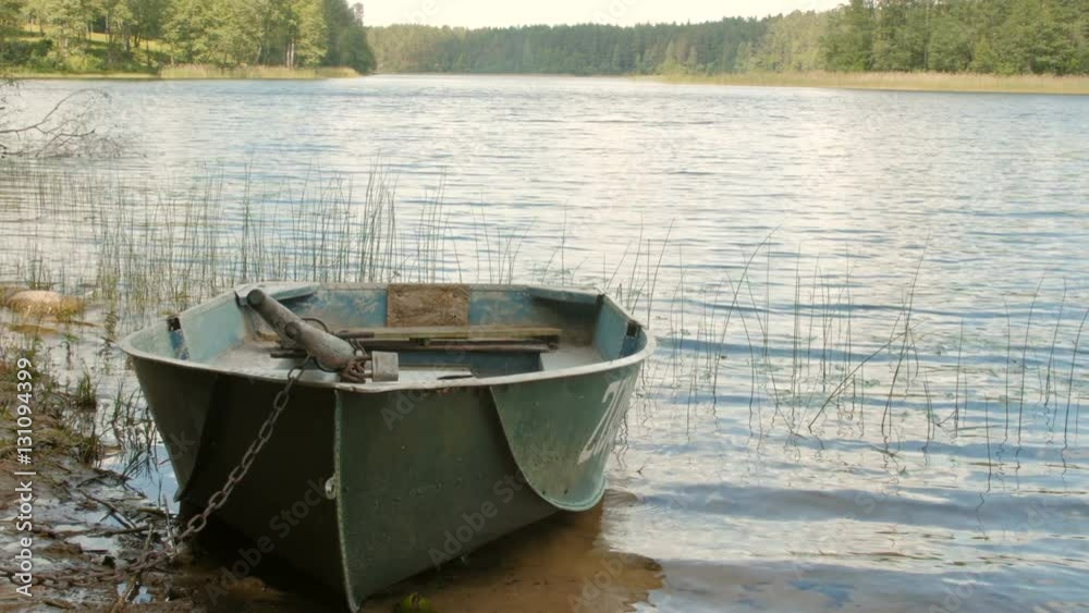 Boat locked with a chain in the lake Boat locked with a chain in the lake