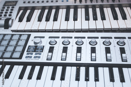 Close up MIDI Controller, keys  and feders photo